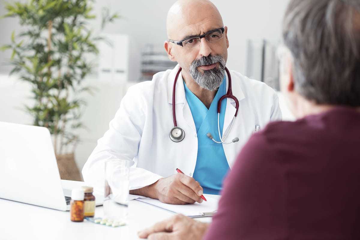 Ratgeber Rheuma: Ein älterer Arzt im Gespräch mit einem Patienten Ratgeber Rheuma: Ein älterer Arzt im Gespräch mit einem Patienten