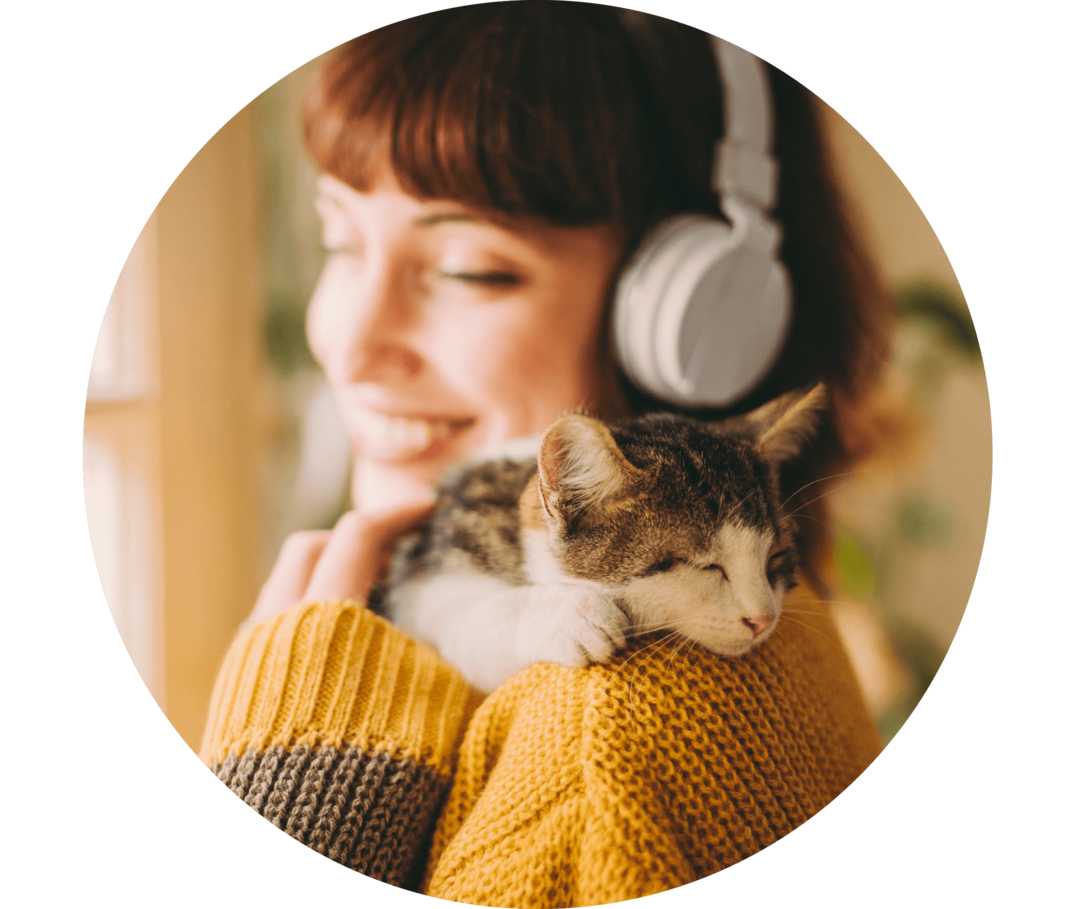 Ratgeber Rheuma: Eine Patientin schmust mit ihrer Katze und hört einen Podcast