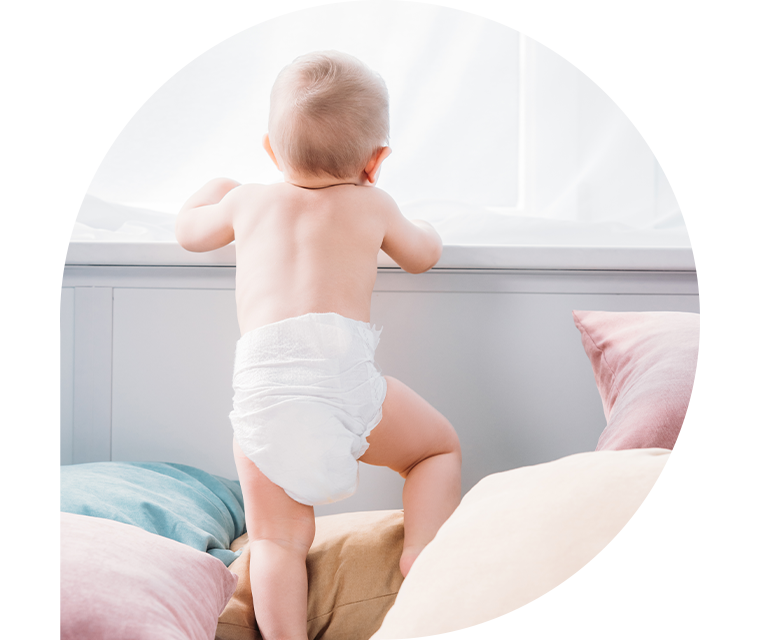 Baby klettert auf Kissen herum 